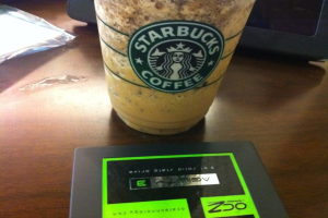 Ein Starbucks-Kaffeebecher auf einem Tisch mit anderen Gegenständen.