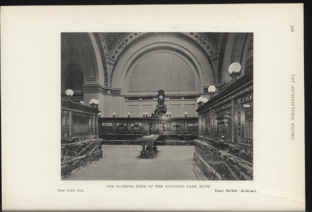 Schwarzes und weißes Foto des Banketts des National Park Bank in New York City, das Tische, Lampen, eine Wanduhr und Text am Boden zeigt.